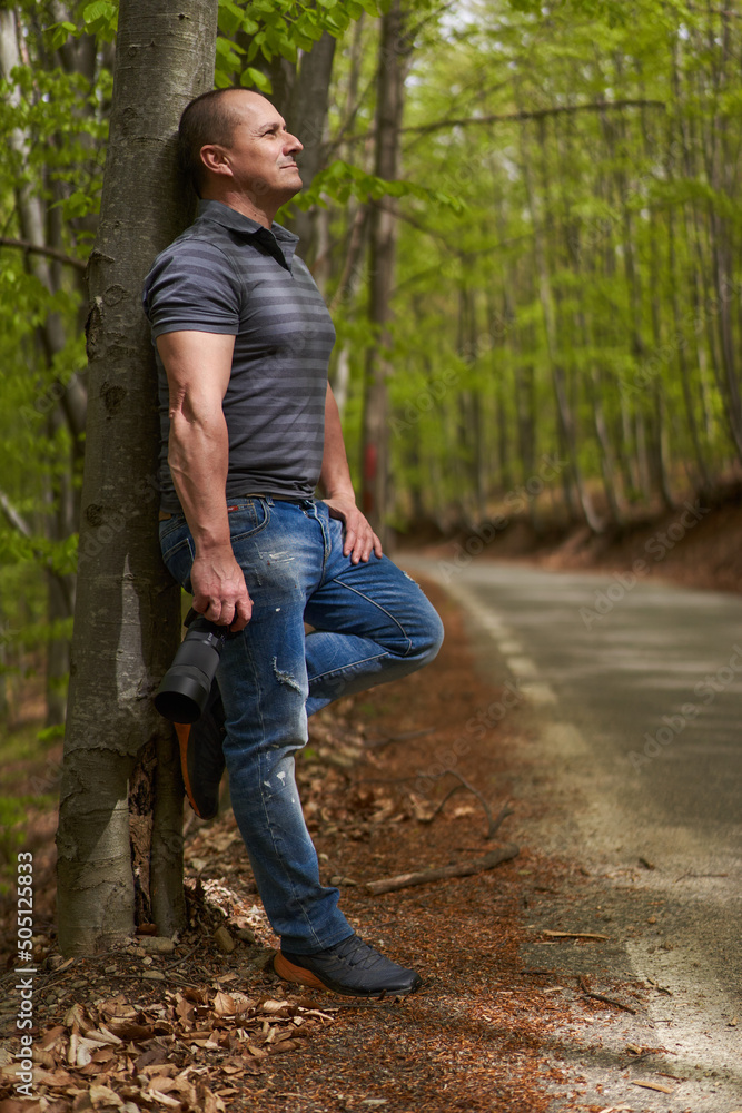 Photographer shooting in a deciduous forest Photographer shooting in a deciduous forest