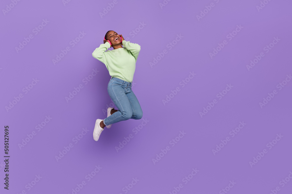 Full size photo of happy emotion female enjoying her favorite rock band in headset isolated on purple color background