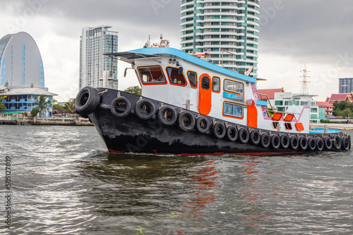 A Tugboat at the Chao Phraya River in Bangkok Thailand Asia photo