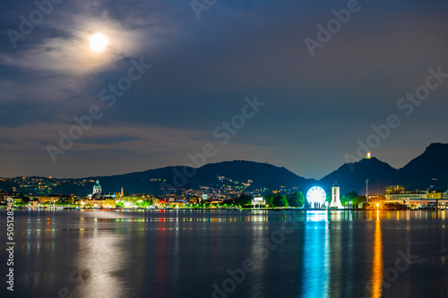 The city of Como, photographed in the evening, with the lakefront, the cathedral, and the surrounding mountains.  © leledaniele