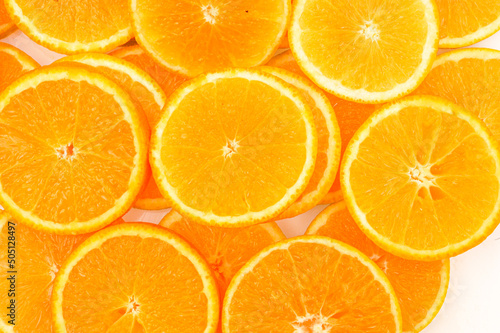 Abstract background with citrus-fruit of orange slices. Close-up of orange slices on white background.