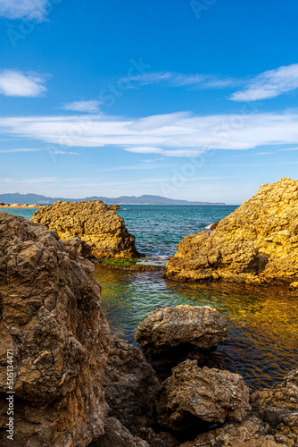 View of the natural arch of the beach of Portitxol in L'Escala, Costa Brava - Girona, Spain