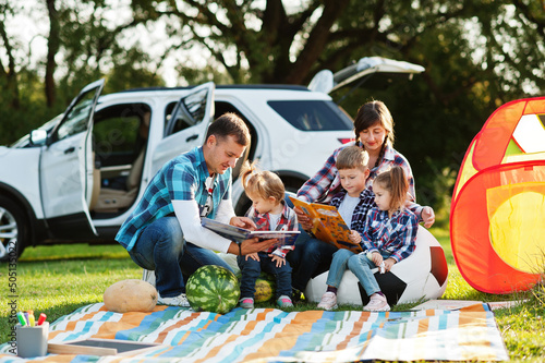 Family spending time together. Three kids. Outdoor picnic blanket. © AS Photo Family