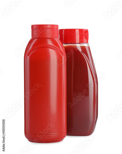 Different bottles of ketchup on white background