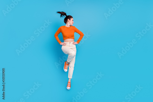 Fototapeta Naklejka Na Ścianę i Meble -  Full length photo of active energetic positive girl jumping up have fun isolated on blue color background