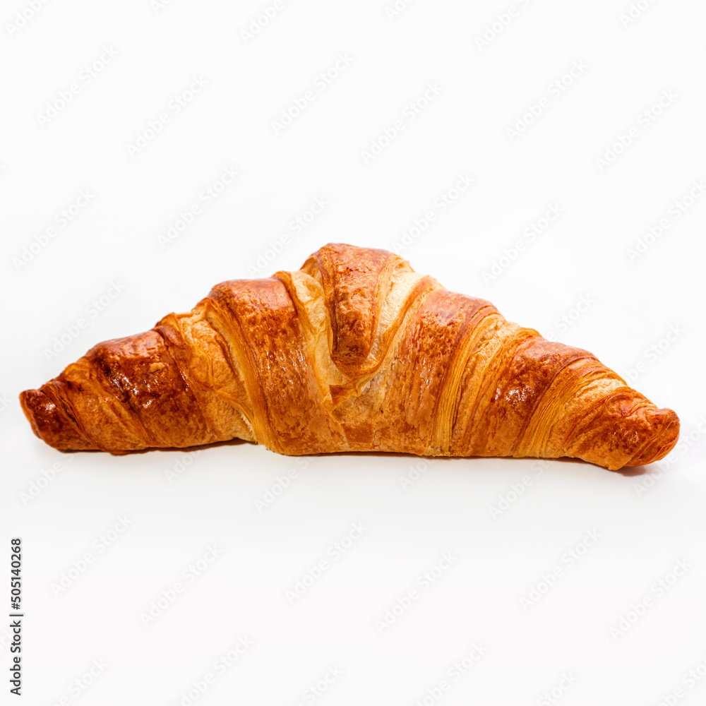 Fresh crispy croissant on a white background, close-up. Pastries and sweets. Copy space
