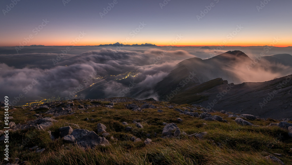 Sunset in the mountains with fog in the valley.