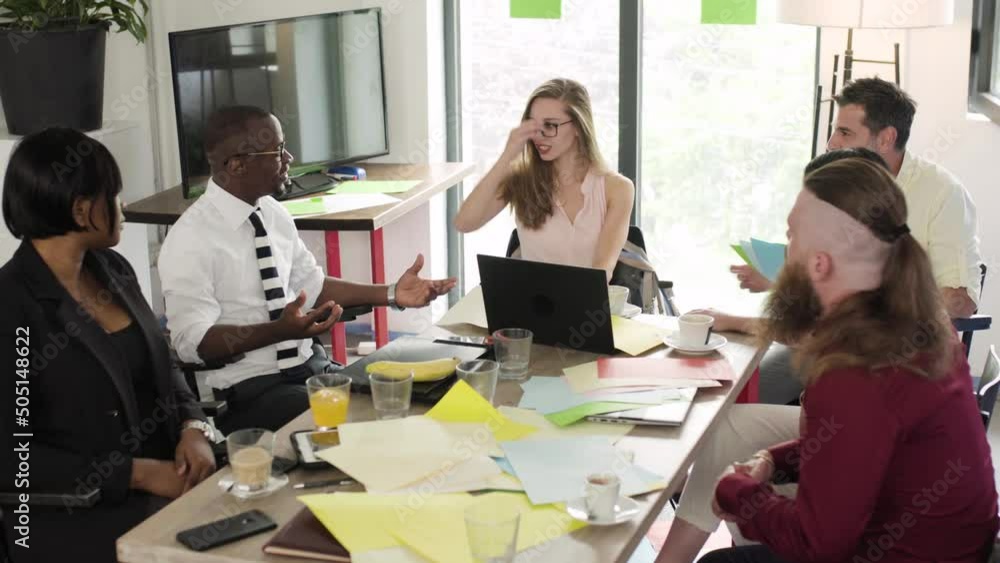 Group of people working in an office. Business meeting of multiracial startup team. Successfull colleagues brainstorming.. Group of people working in an office. Business meeting of multiracial startup team. Successfull colleagues brainstorming..