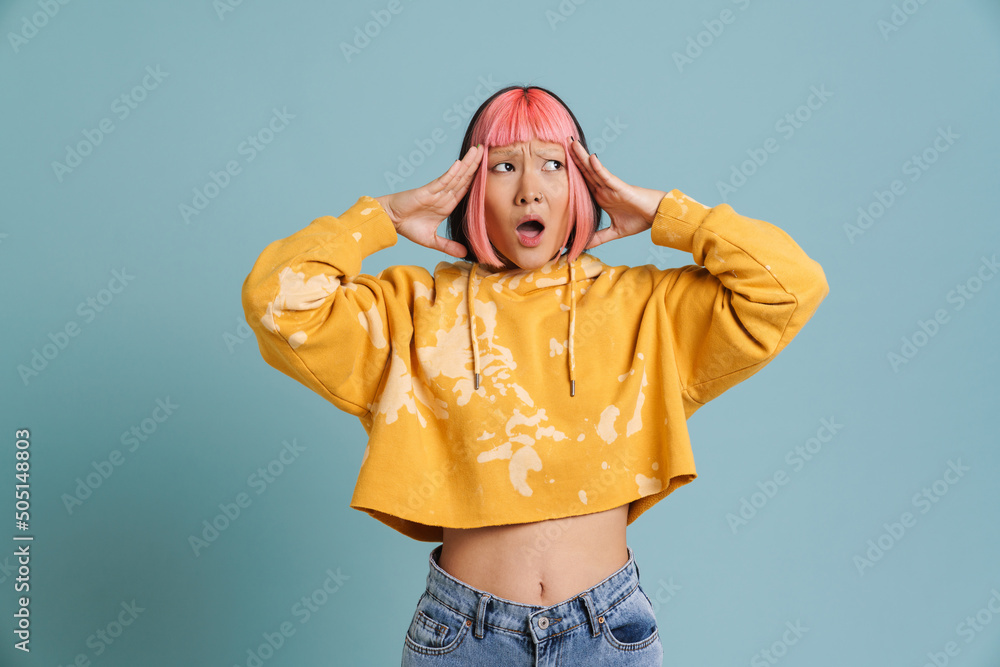 Asian girl with pink hair and piercing expressing surprise at camera - obrazy, fototapety, plakaty 