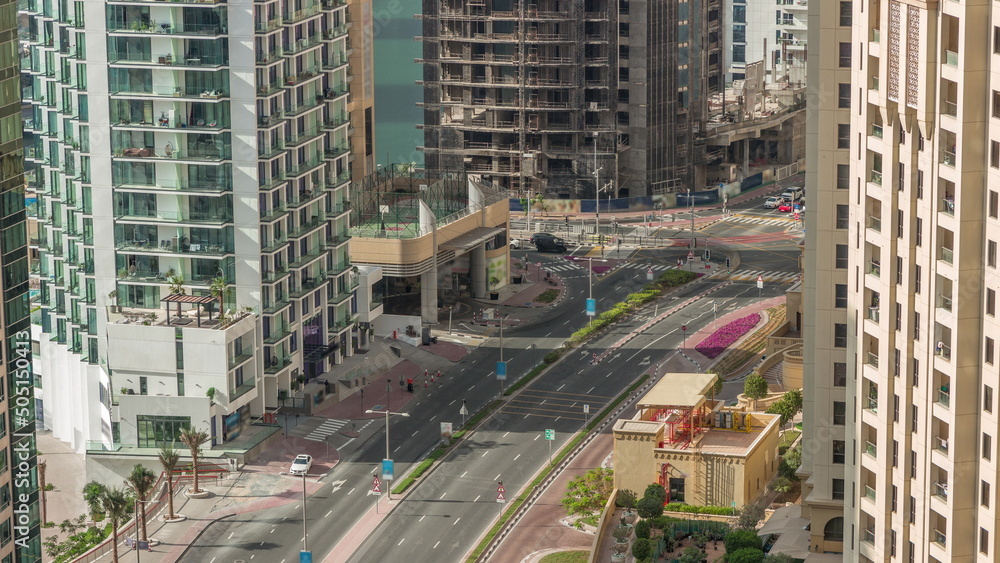 Fototapeta premium Aerial view of JBR street with heavy traffic timelapse. Dubai road and intersections.