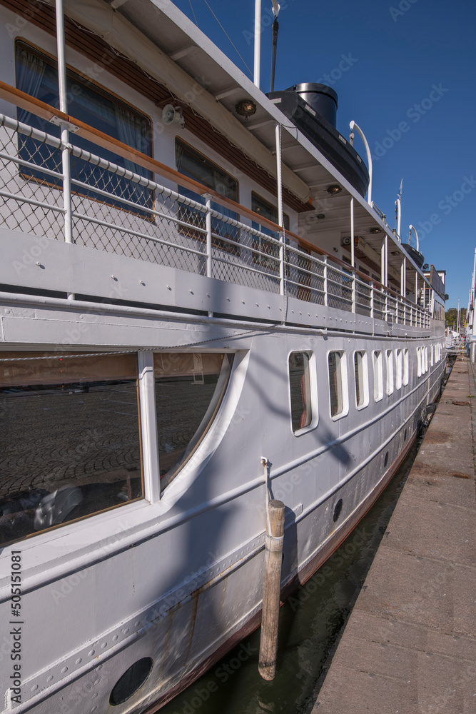 Naklejka premium An old steam boat not in duty at a pier in the bay Nybroviken a sunny day in Stockholm