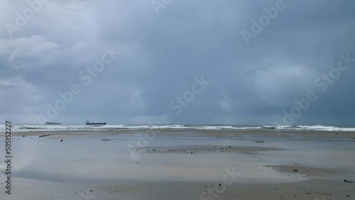 Storm on the winter sea with two ships on the horizon