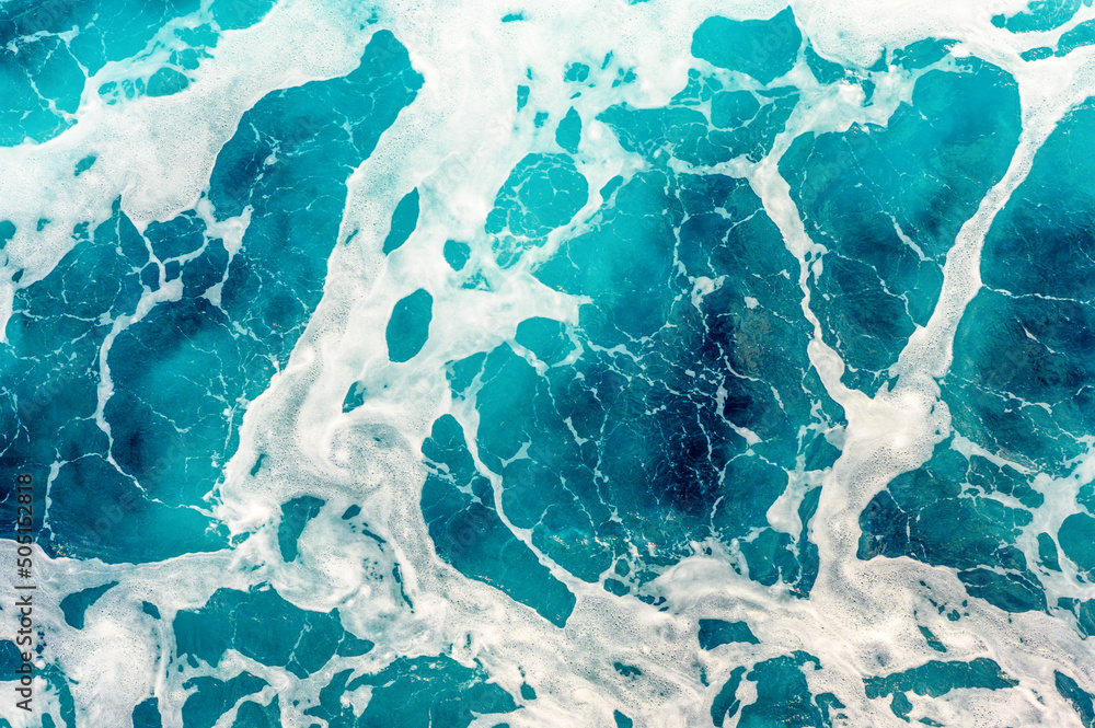 Top view of colorful turquoise sea water on a sunny day. Background