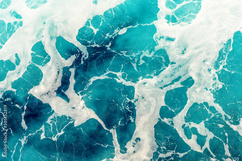 Top view of colorful turquoise sea water on a sunny day. Background