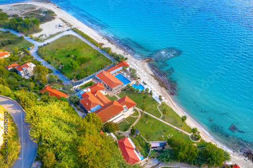 Beautiful Aerial view Beach resort with hotel on the shores of the beautiful seaside. Hotel with swimming pool on the shores of the Ionian Sea.