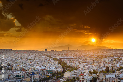 Obraz na płótnie Panorama of the Greek capital Athens at sunset with a sky overcast with thunderclouds, Greece, Europe. View of the city from above. w salonie