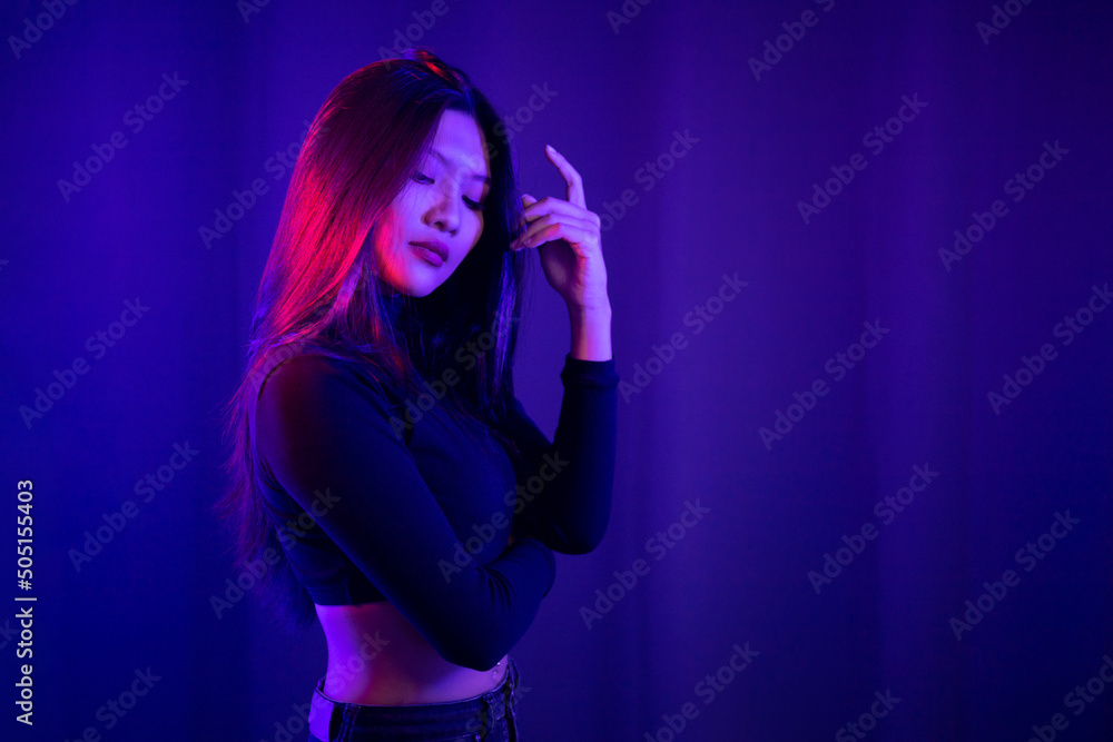 Stylish sexy woman in trendy. Beautiful young asian woman standing pose with neon light. Asia Pretty asian female in the dark room. Fashion shot. Stylish sexy woman in trendy. Beautiful young asian woman standing pose with neon light. Asia Pretty asian female in the dark room. Fashion shot.