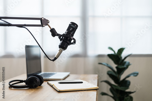 Condenser microphone in recording home studio. Content creator working with laptop host streaming radio podcast interview conversation at home broadcast studio recording voice over radio photo