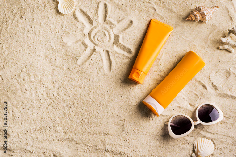 Sunscreen lotion on sandy beach Stock Photo | Adobe Stock