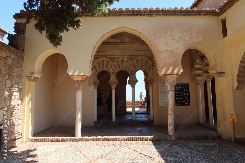 Malaga, Spain, May 8, 2022: Islamic arches inside the Alcazaba of Malaga. Palatial fortification from the Islamic era built in the 11th century