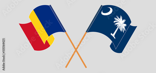 Crossed and waving flags of Romania and The State of South Carolina