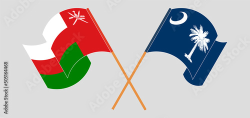 Crossed and waving flags of Oman and The State of South Carolina