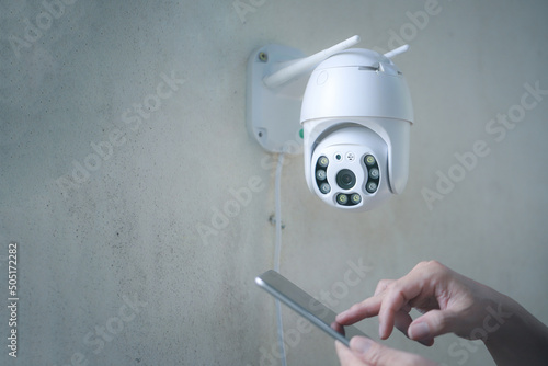Man installing security camera CCTV wireless security equipment water proof cover to protect camera with home security system concept.
