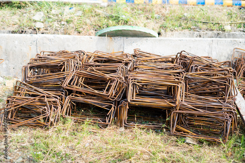 Pan shot of building bent iron rods near home construction place. photo