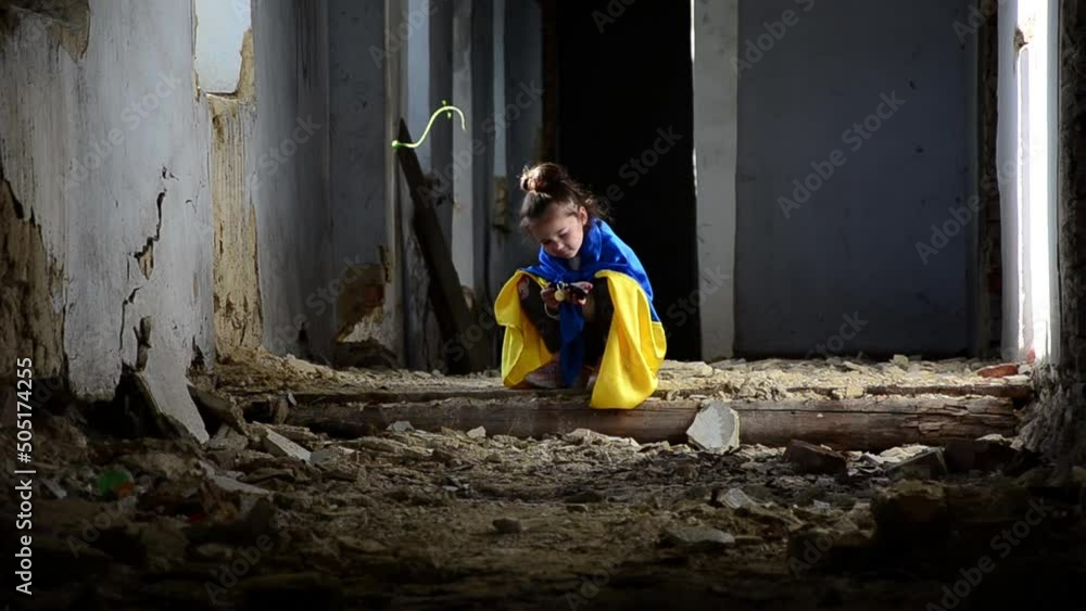 Child in prayer for Ukraine. War in Ukraine. A child in the slums ...