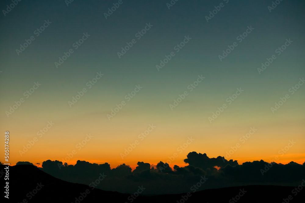 Vivid colours of a winter sunset, with low cumulus clouds on the horizon. Cyprus