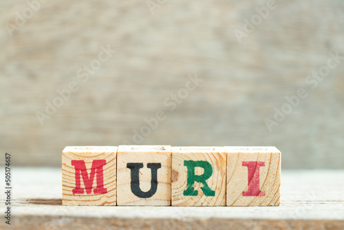 Alphabet letter block in word muri on wood background photo