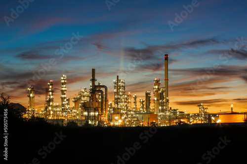 Oil​ refinery​ and​  plant and tower column of Petrochemistry industry in oil​ and​ gas​ ​industrial with​ cloud​ orange​ ​sky