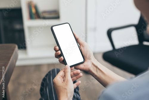 cell phone blank white screen mockup.hand holding texting using mobile on desk at office.background empty space for advertise.work people contact marketing business,technology