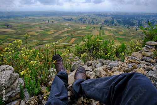 Observer's feet in front of agricultural crops in the Mantaro Valley, seen from the Arwaturo viewpoint photo