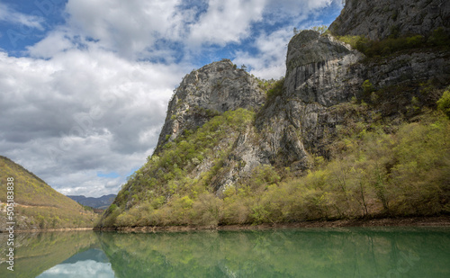 Cruise on the emerald waters of the Drina River with reflections and beautifully merging mountain ranges.