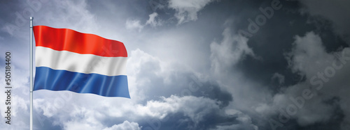 Netherlands flag on a cloudy sky