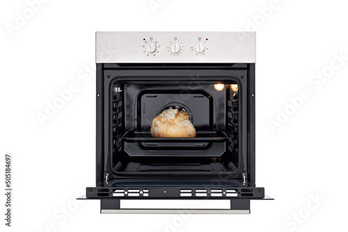 Black oven with silver control panel, three round control knobs. Open door and baked bread inside, lights on inside. Front view. Isolate on white