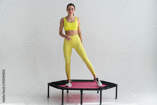 young fitness woman In sportswear jumping on sport trampoline