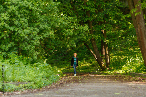 beautiful girl walking in summer park