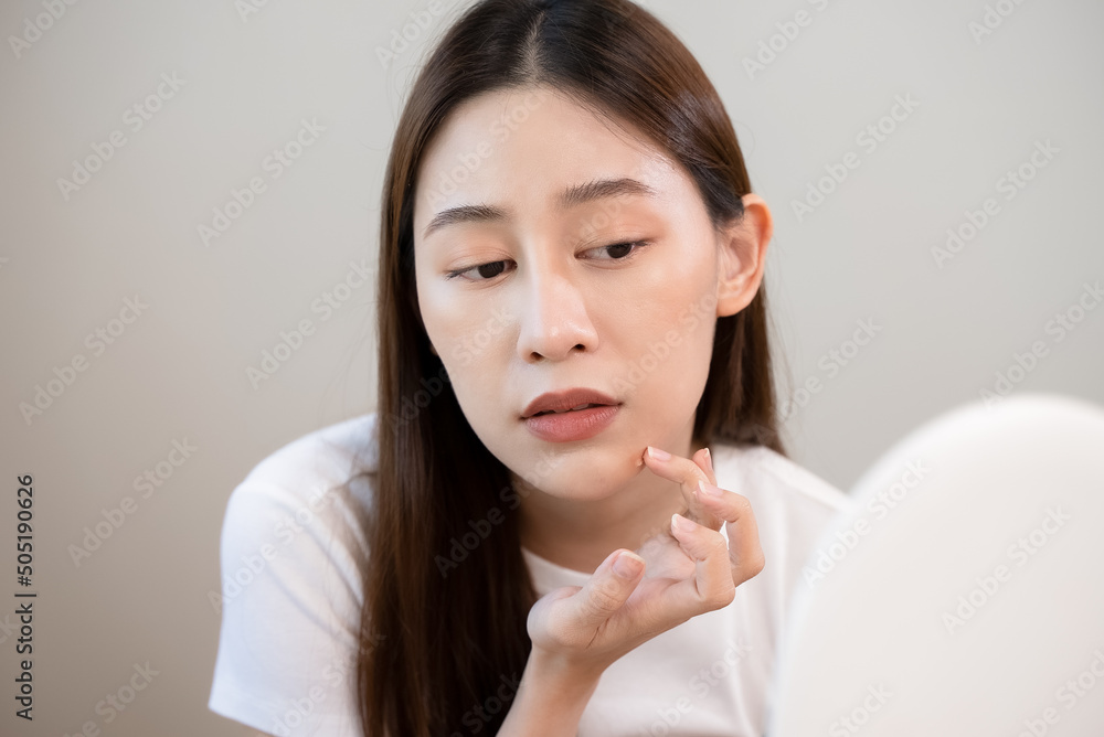 skin problem treatment. Women looking acne on her face in the mirror. skin problem treatment. Women looking acne on her face in the mirror.