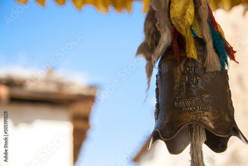 Tibetan bell hanging on the roof at Ganden Sumtseling Monastery