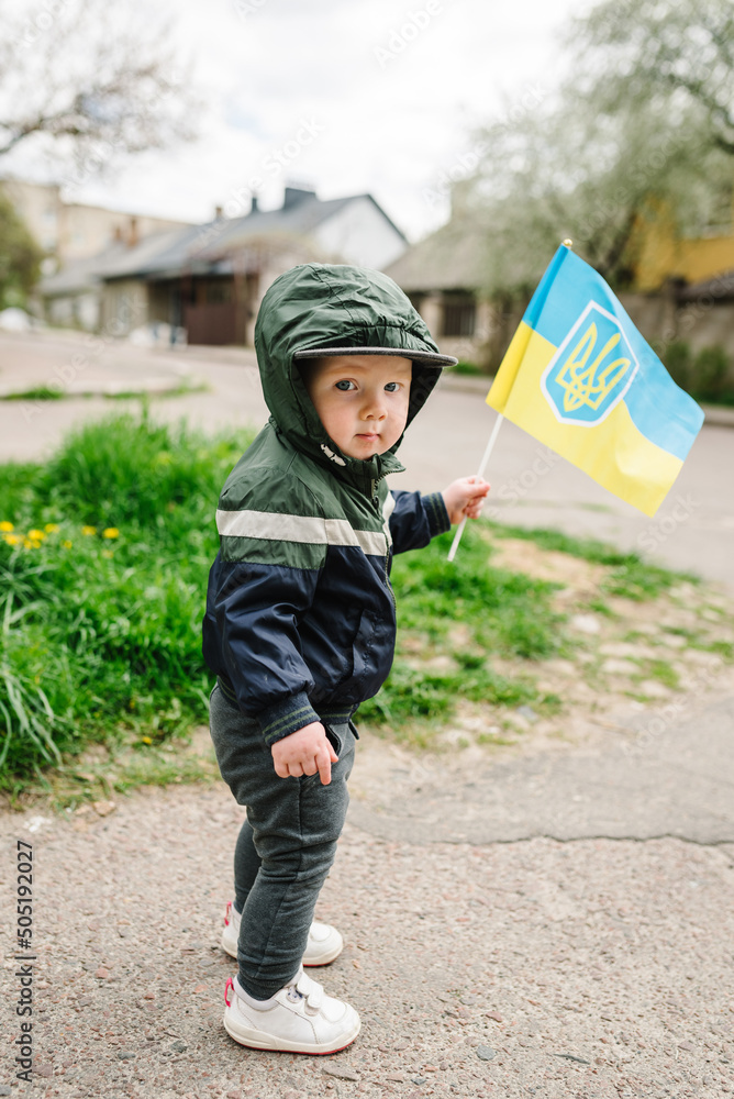 Child boy holding Ukrainian flag, asking for peace, children against war, kids in danger, stop fighting. National symbol of freedom and independence. Hope and Faith. Support for Ukraine. No war. Child boy holding Ukrainian flag, asking for peace, children against war, kids in danger, stop fighting. National symbol of freedom and independence. Hope and Faith. Support for Ukraine. No war.