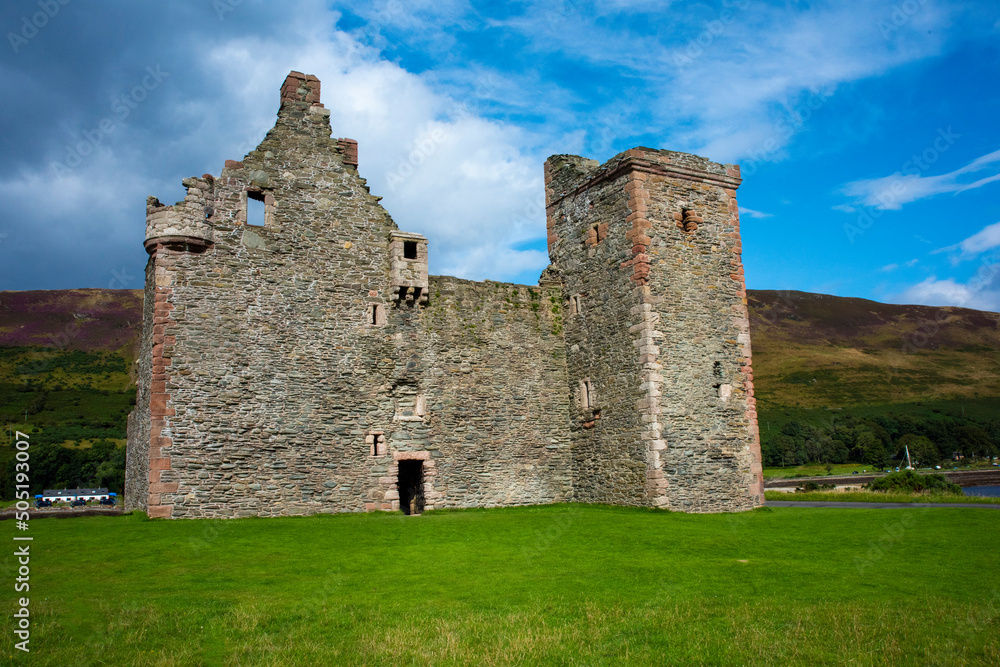 Old abandoned castle with hills in background and moody sky Old abandoned castle with hills in background and moody sky
