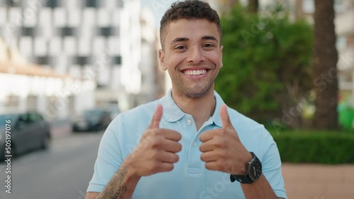 African american man smiling confident doing ok sign with thumbs up at park photo