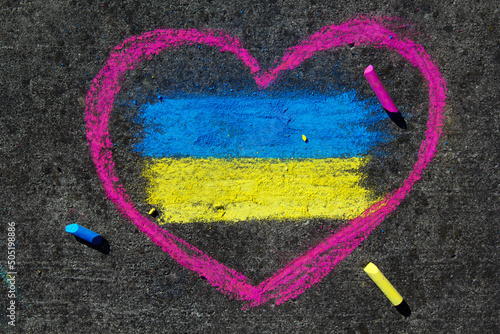 Flag of Ukraine and pink heart. Chalk drawing on sidewalk. Support for Ukraine.