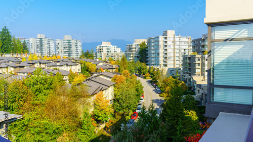 Aerial view of UniverCity Highlands on Burnaby Mountain, BC, seen from a neighborhood patio garden as Autumn colors start to come in.