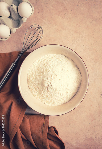 Obraz na plátně Food background, concept, plate with wheat flour, whisk for whipping, kitchen to