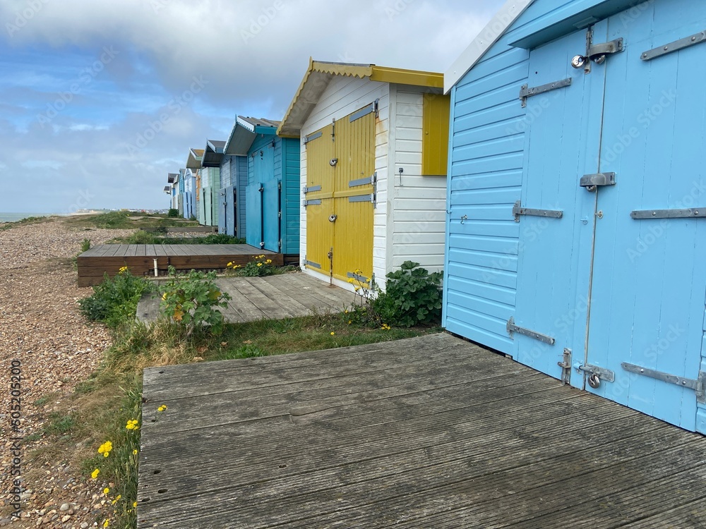 bulverhythe beach, West St. Leonards, East Sussex, UK - 20.05.22: beautiful shingle pebble beach with beach huts boats bulverhythe beach, West St. Leonards, East Sussex, UK - 20.05.22: beautiful shingle pebble beach with beach huts boats