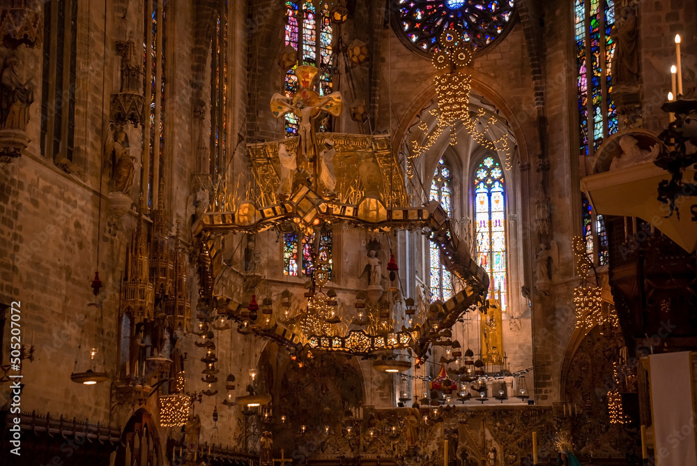 Obraz premium Low angle view of beautiful altar in medieval La Seu Cathedral. Creative decoration hanging over gothic church. Interior of old religious building.