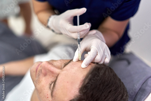 Patient getting a shot of botox in the forehead
